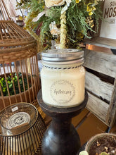 Load image into Gallery viewer, Candle labeled 'Apothecary' on a wooden stand with decorative items in the background